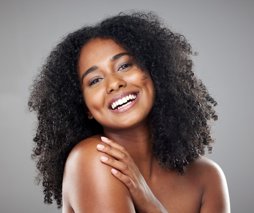 Face, beauty and skincare with a model black woman in studio on a gray background with a happy smile. Portrait, cosmetics and wellness with an attractive young female