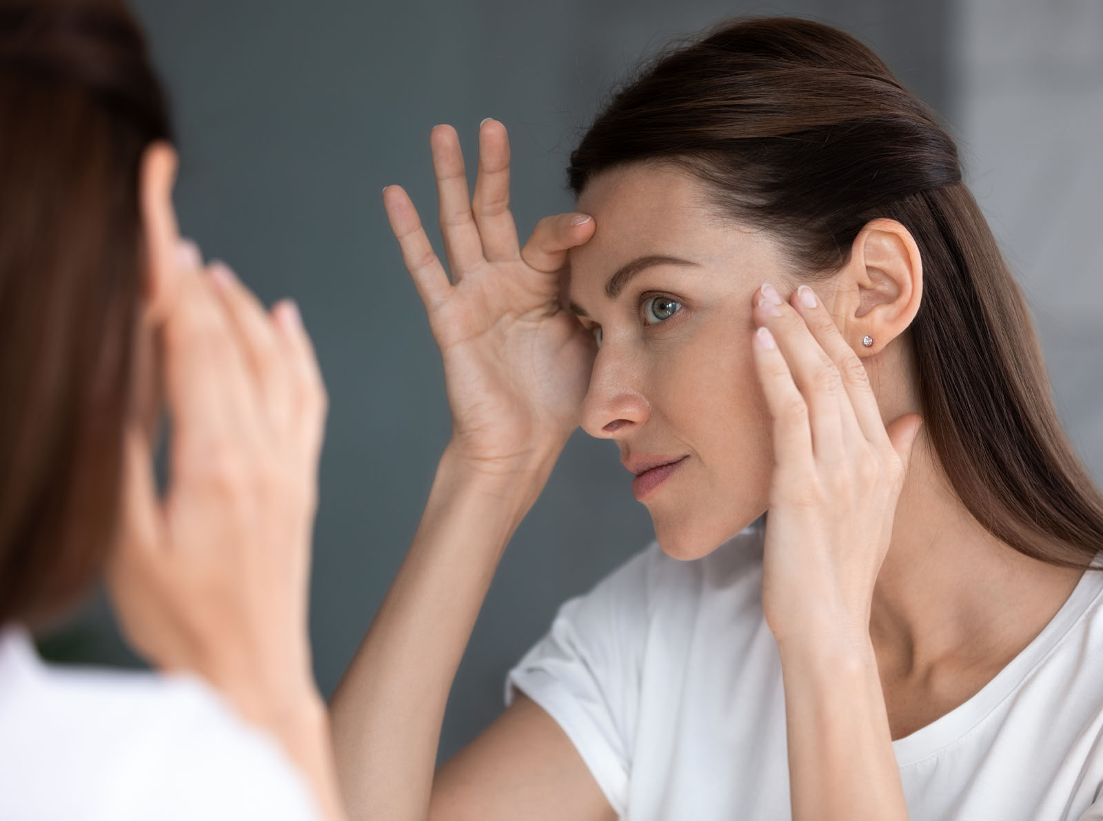 Close up of woman looking in mirror check face